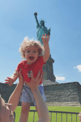 Eddie in front of the statue of liberty