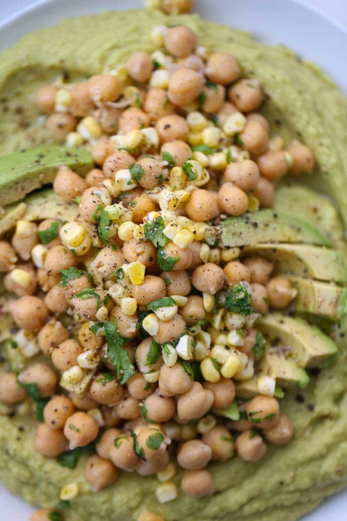 Southwest Guacamole Hummus is a crazy creamy spicy hummus love child. Garbanzo beans, ripe avocado, garlic, jalapenos and lemon juice all make up this delicious dip! 