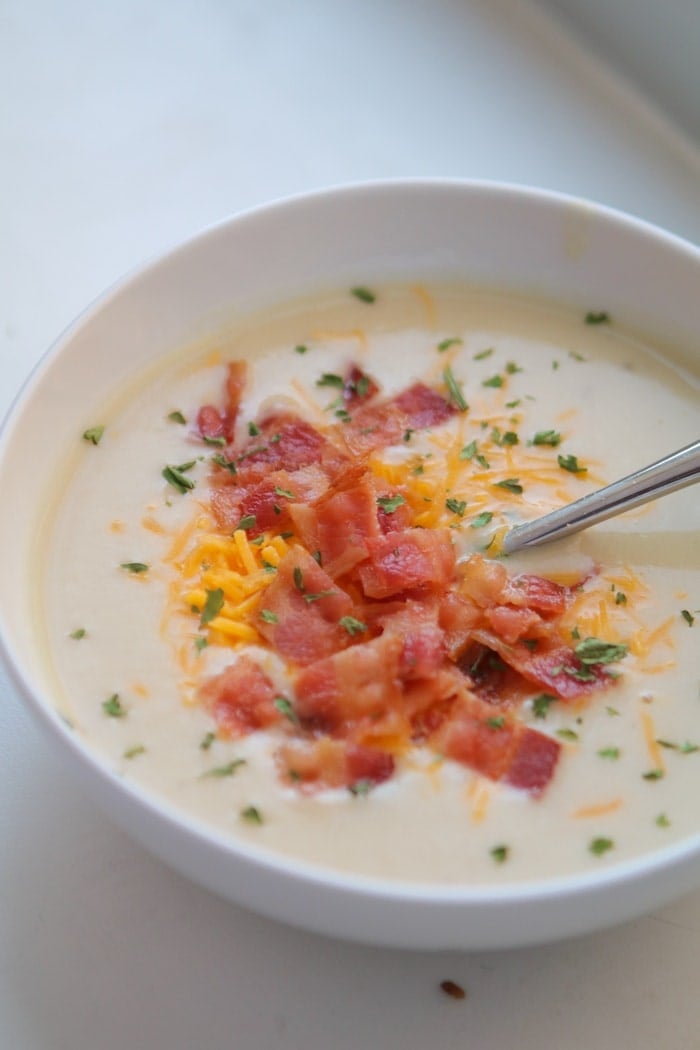 Cauliflower Soup in a bowl with bacon and cheese