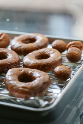 Pumpkin Donuts with glaze on drying rack