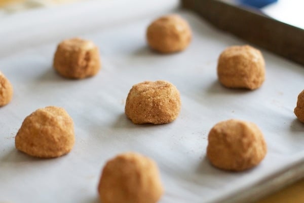 Snickerdoodle Cookie Dough Balls on a parchment paper lined baking sheet