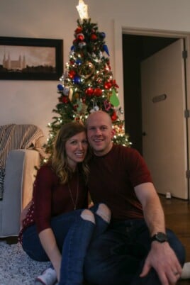 Lauren and Gordon in front of a Christmas tree in their home