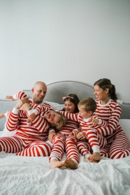 Brennan family in matching pajamas on a bed