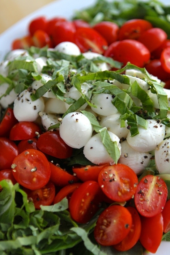 caprese salad laid out in a white dish
