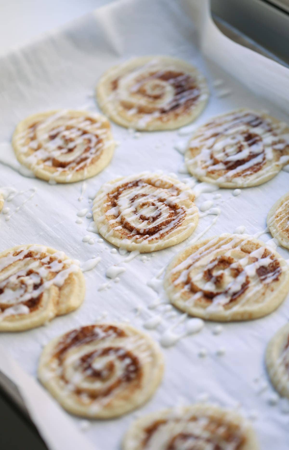 Cinnamon Roll Cookies on a parchment lined baking sheet