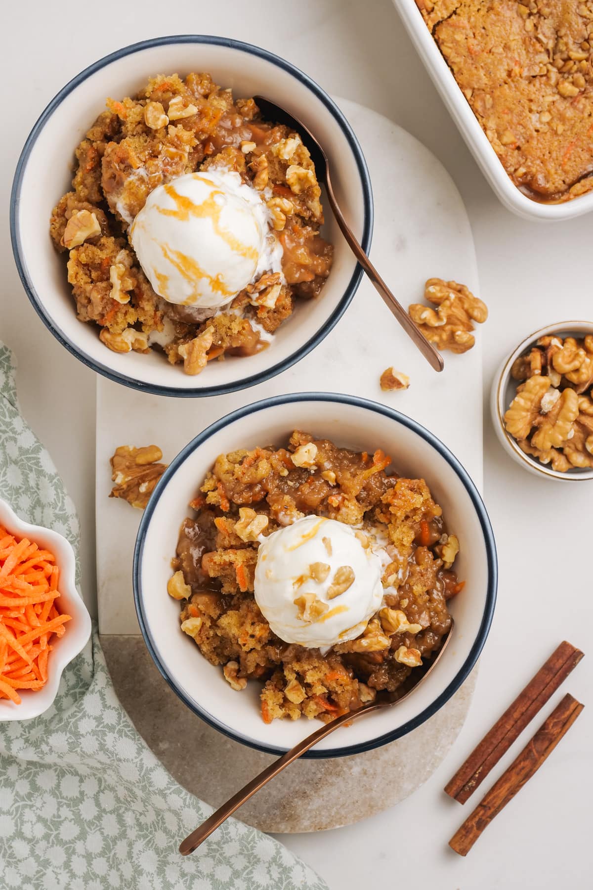 2 bowls with carrot cake cobbler and a scoop of ice cream