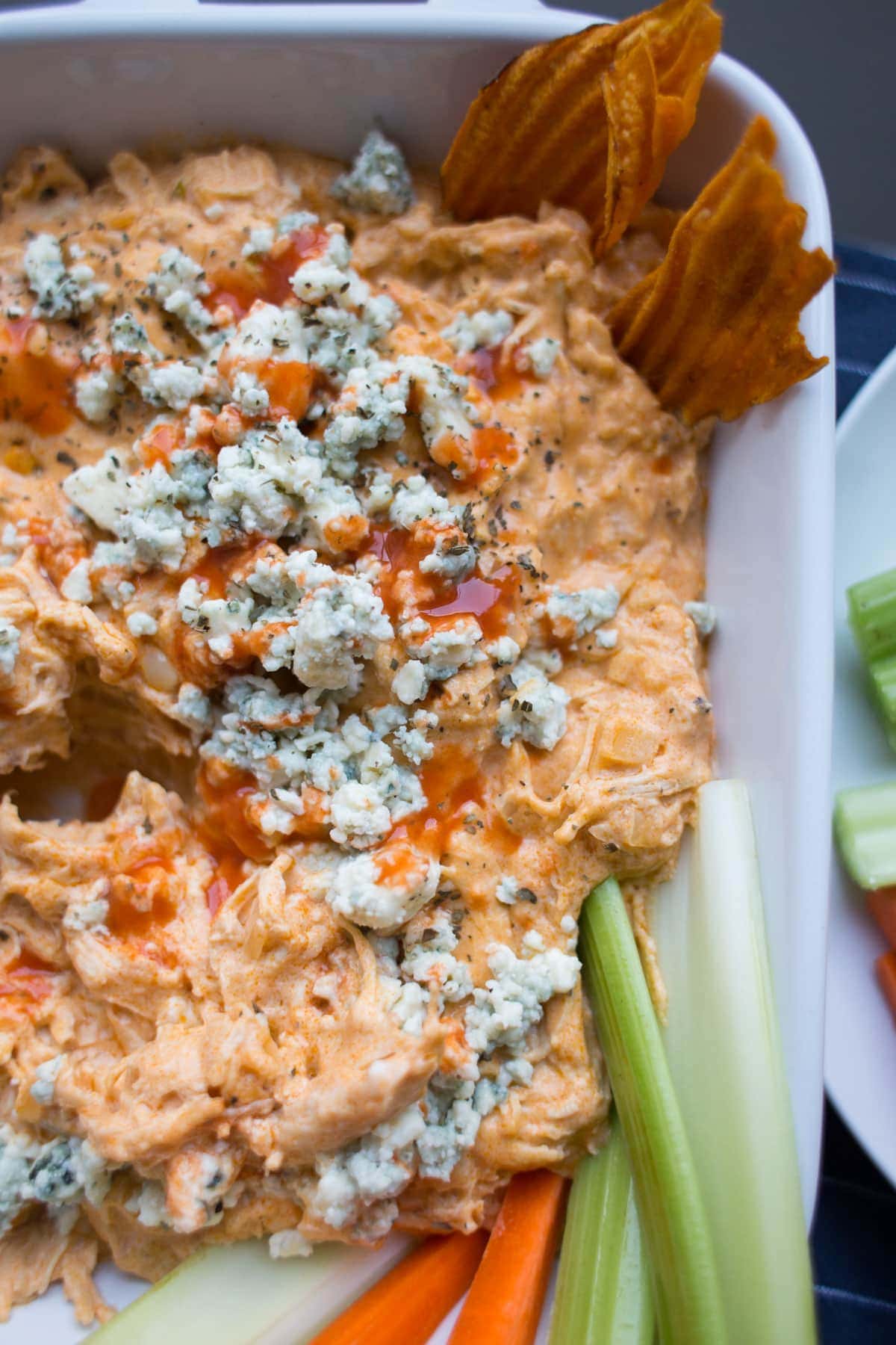 close up of buffalo chicken dip with celery in it