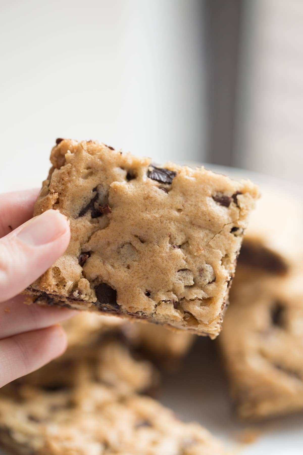 hand holding chocolate chip cookie bar