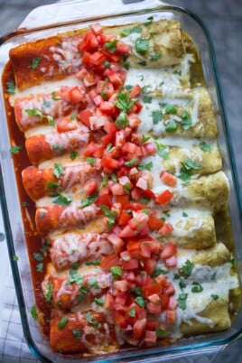 enchiladas with half red and half green sauce on them