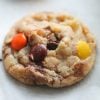 Butterfinger Reese's Pieces Cookie on parchment paper
