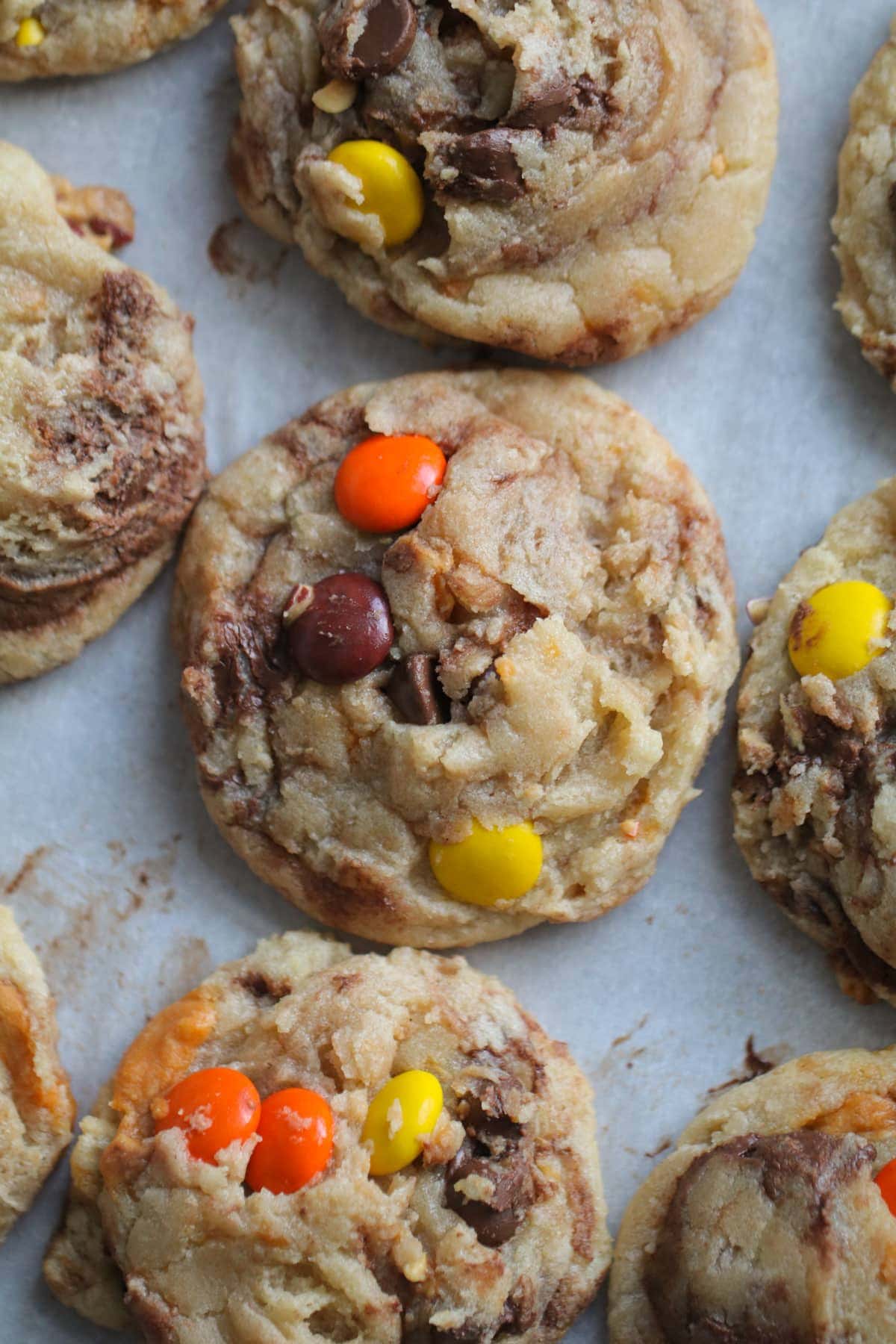 top down view of reeses pieces cookies on a parchment paper lined baking sheet