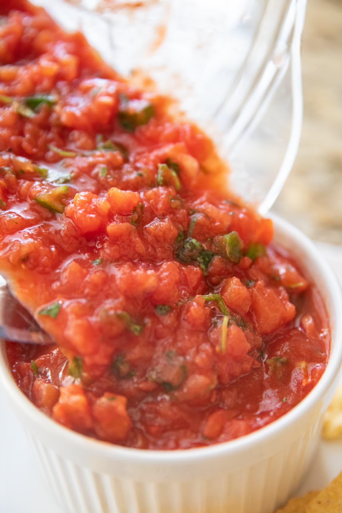pouring salsa recipe into bowl