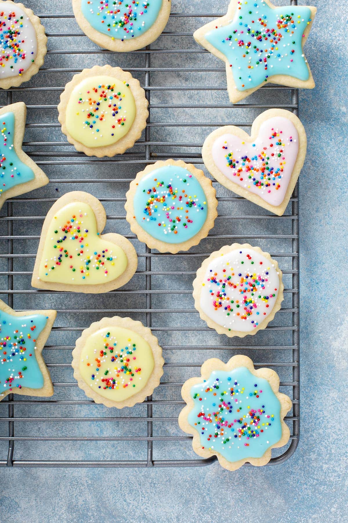 top down view of cut out sugar cookies with icing and sprinkles