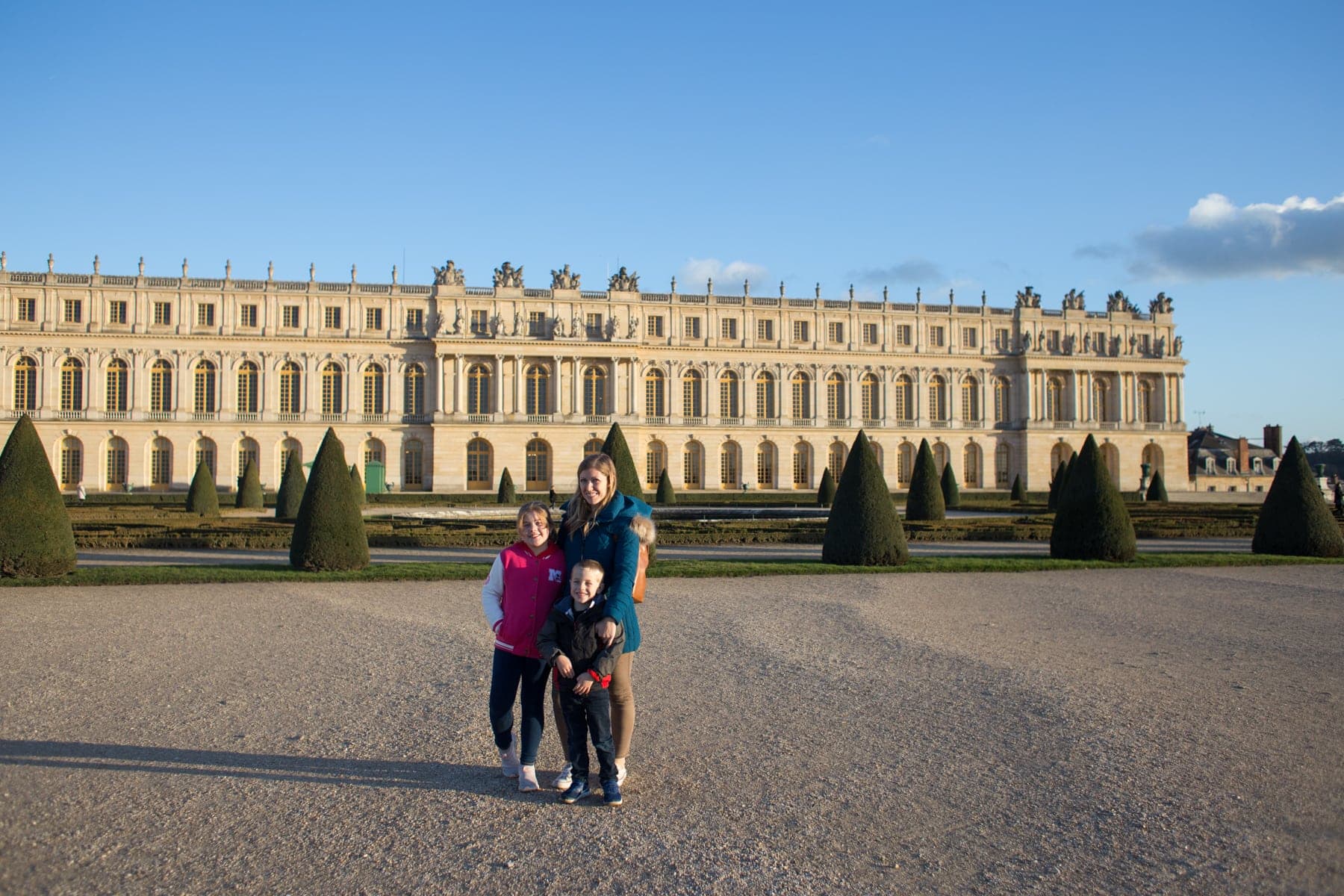 Lauren and kids standing in front of the palace