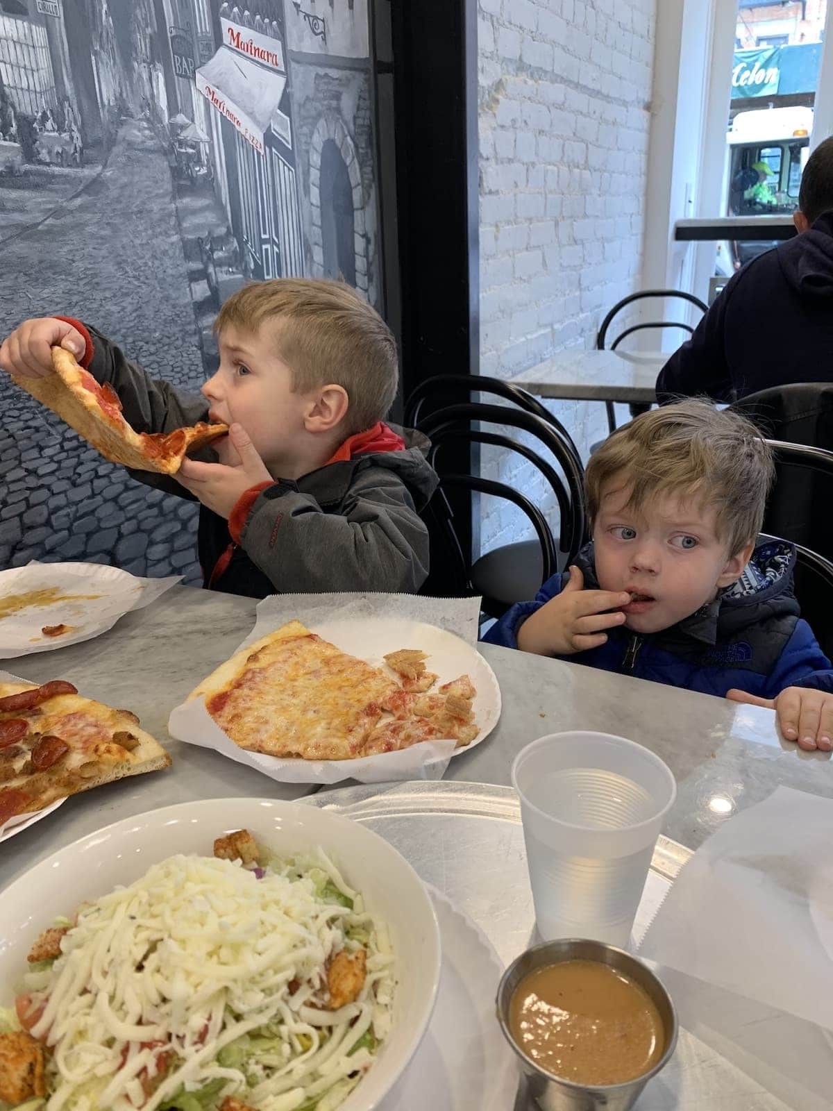 Blake and Eddie eating pizza