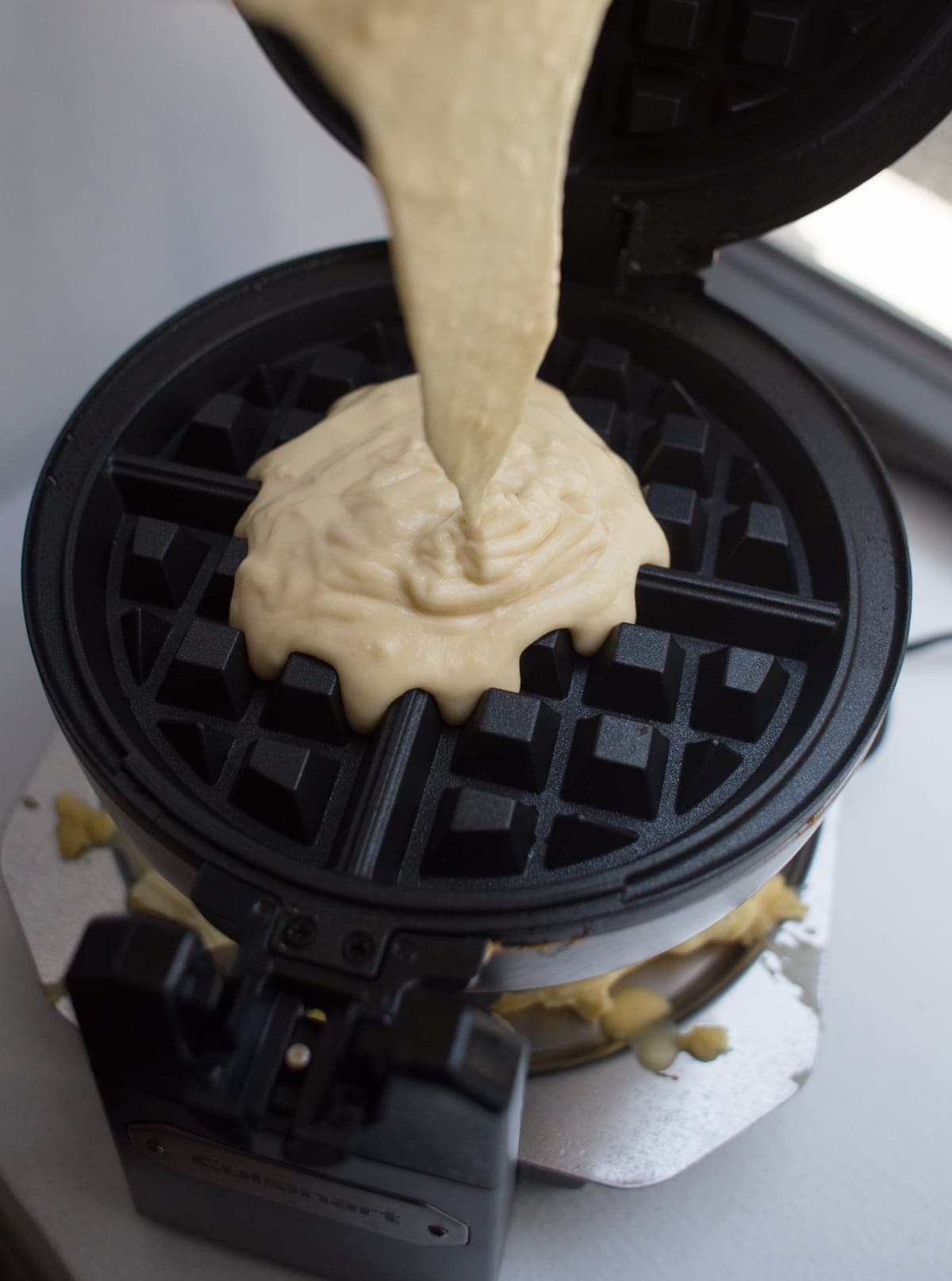 pouring batter into waffle iron