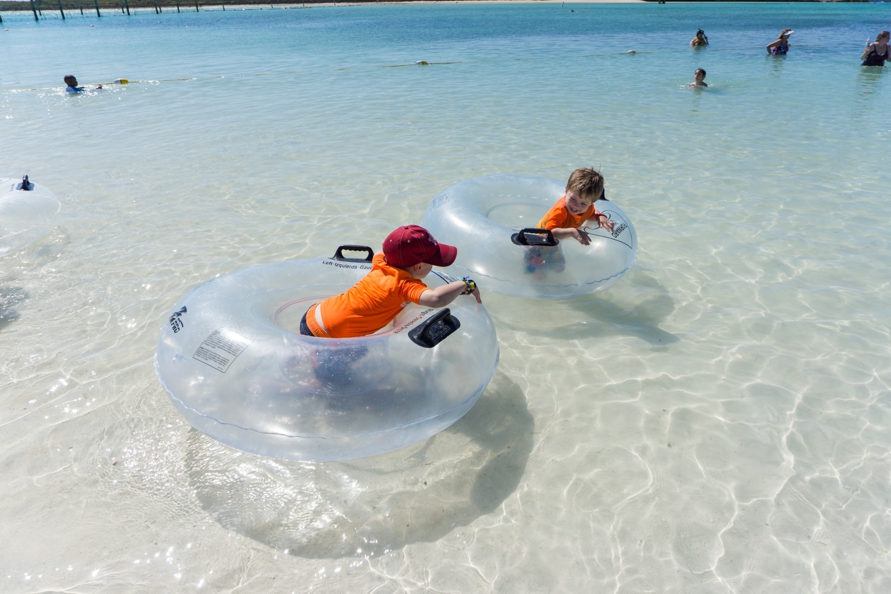 Blake and Eddie in the water with inflatable tubes