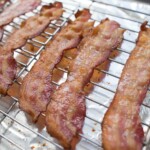 cooked bacon on baking sheet with rack