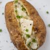Baked potato with butter and scallions