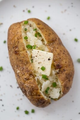 Baked potato with butter and scallions