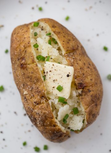 Baked potato with butter and scallions