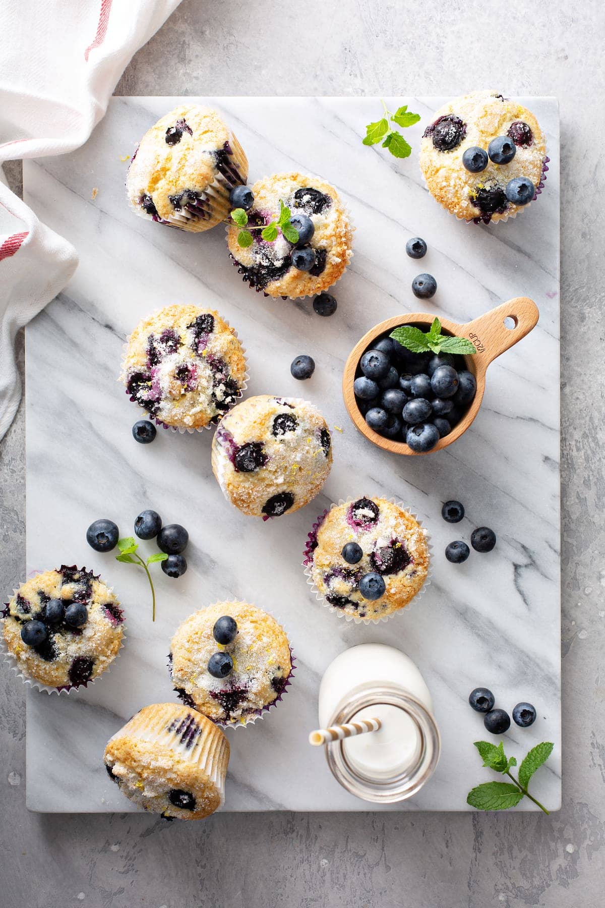 Blueberry muffins styled on a marble countertop