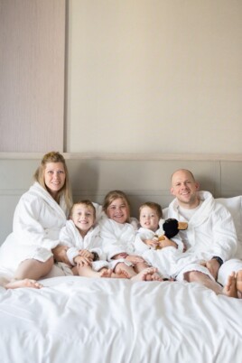 Brennan family in robes lying on a bed