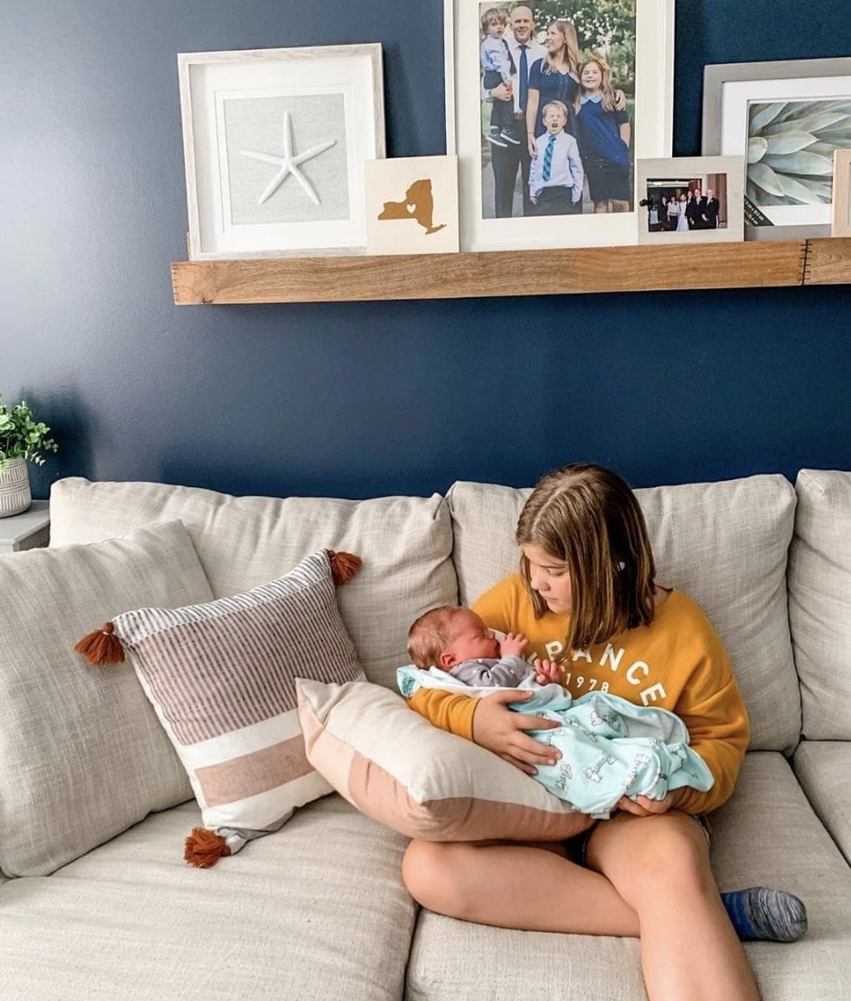 Brooke holding Porter on the couch