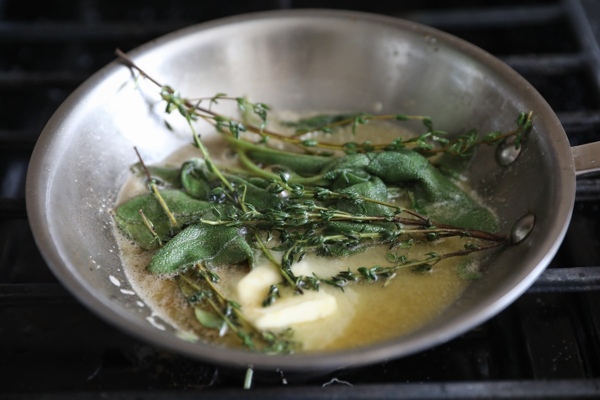 fresh herbs and butter in a skillet