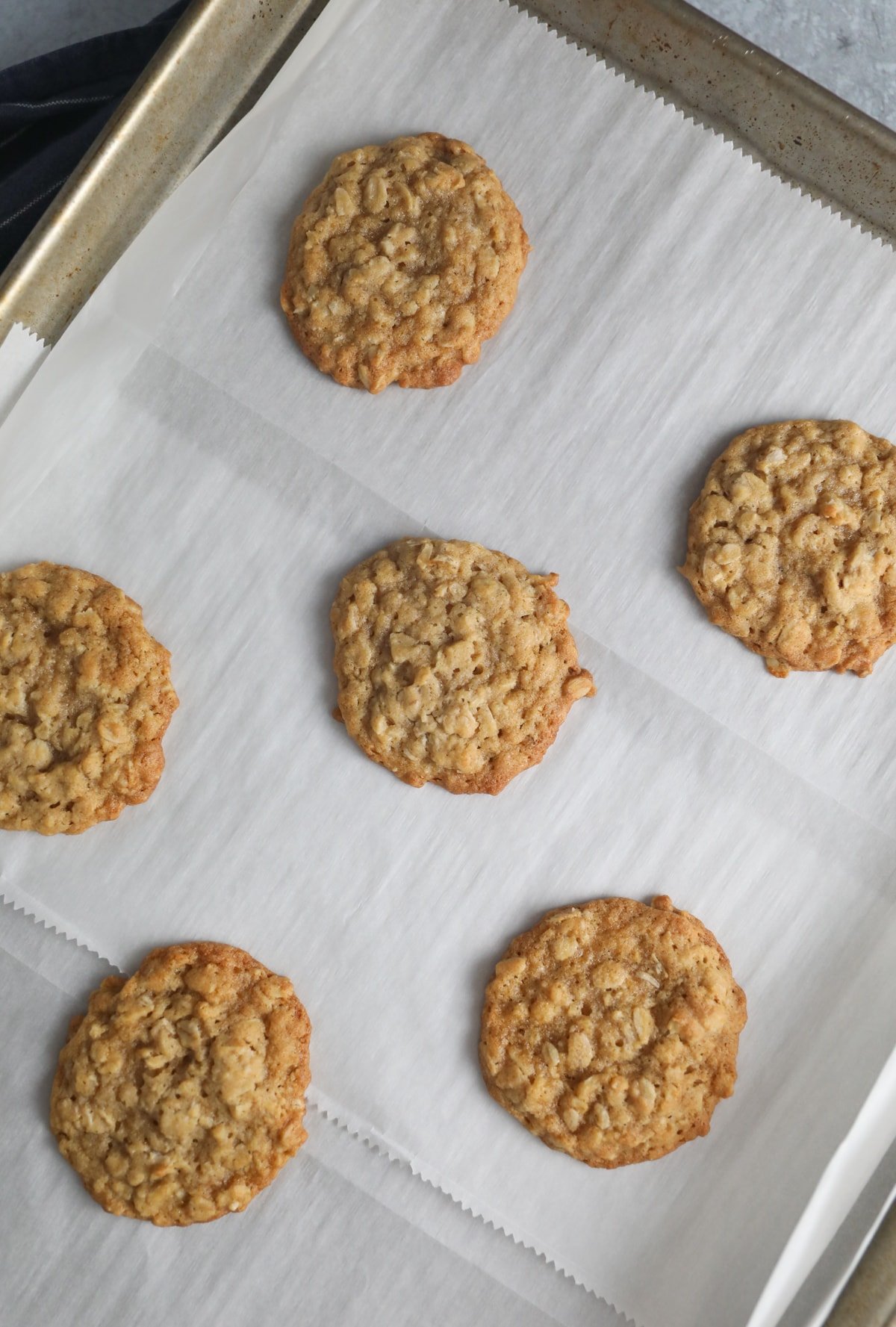 oatmeal cookies on a parchment paper lined baking sheet