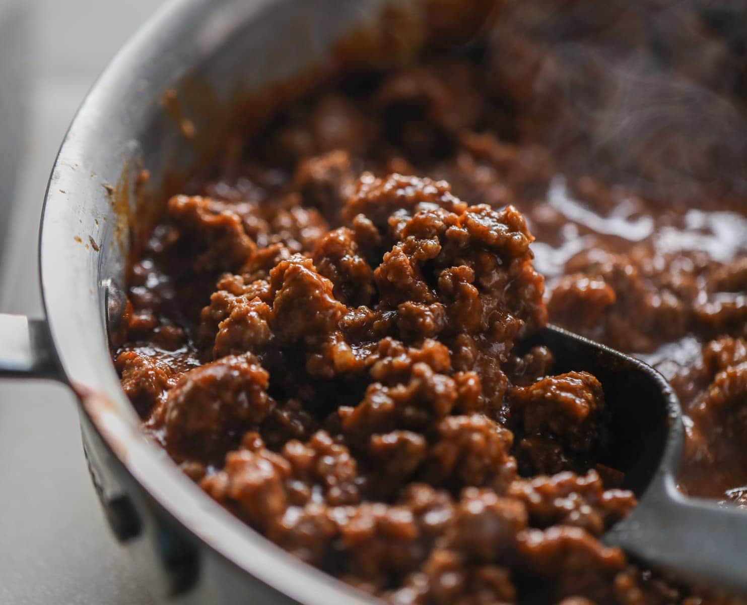Sloppy Joe Mixture in a pan being scooped by a ladle 