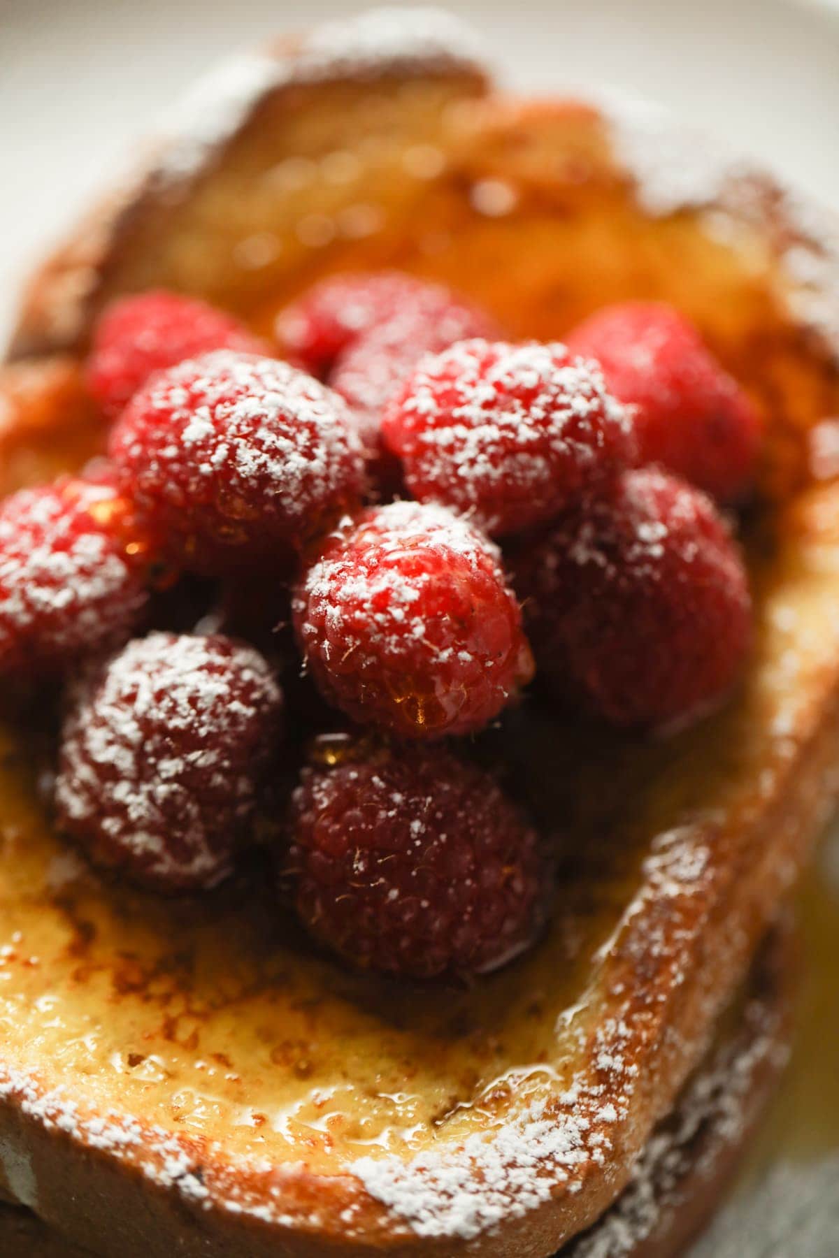 close up of berries and syrup on french toast