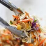 chinese asian slaw toss with tongs