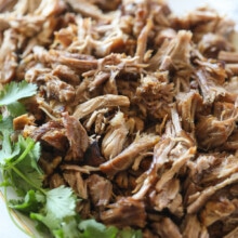 shredded carnitas on platter with cilantro