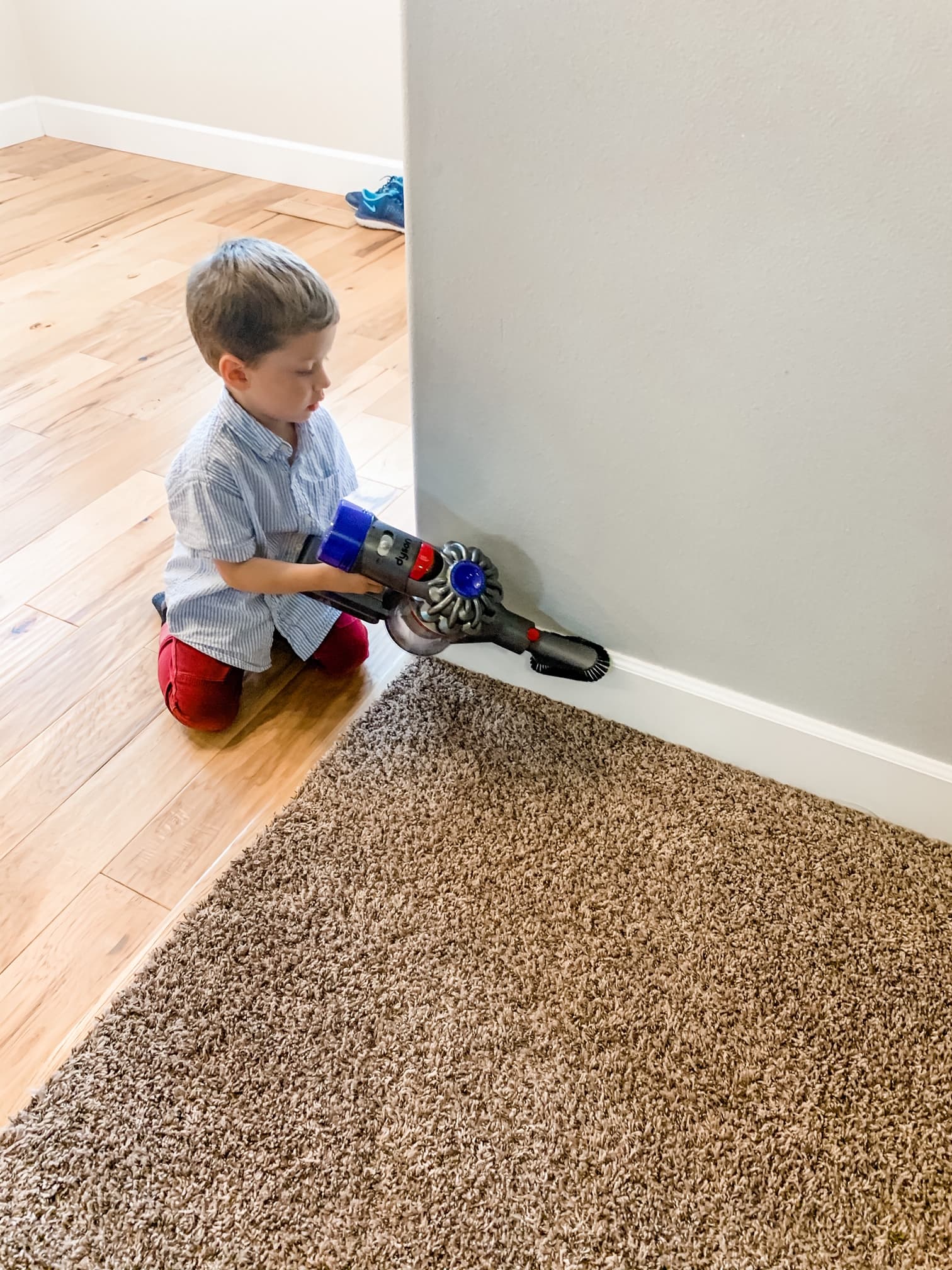 little boy vacuuming