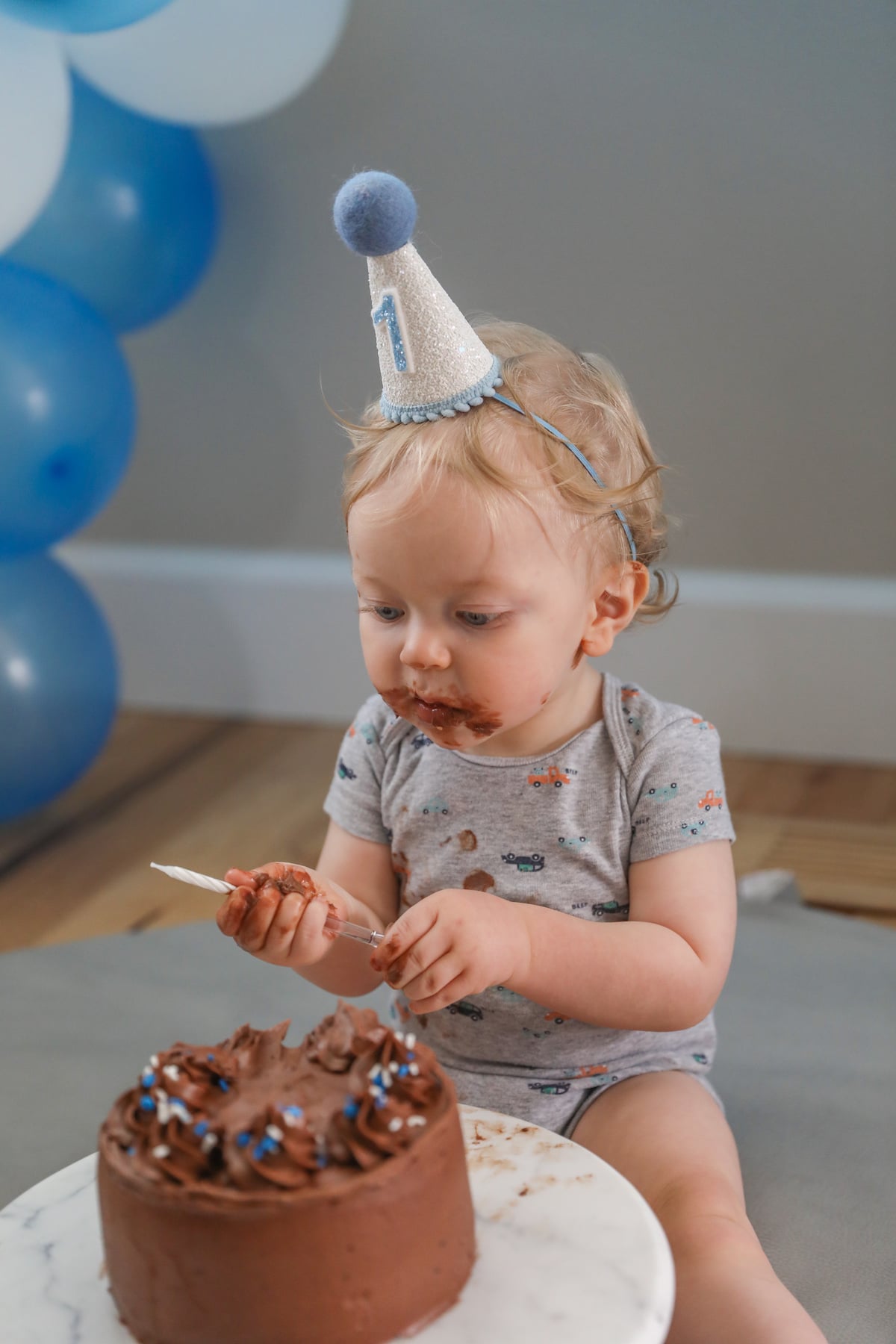baby holding birthday candle