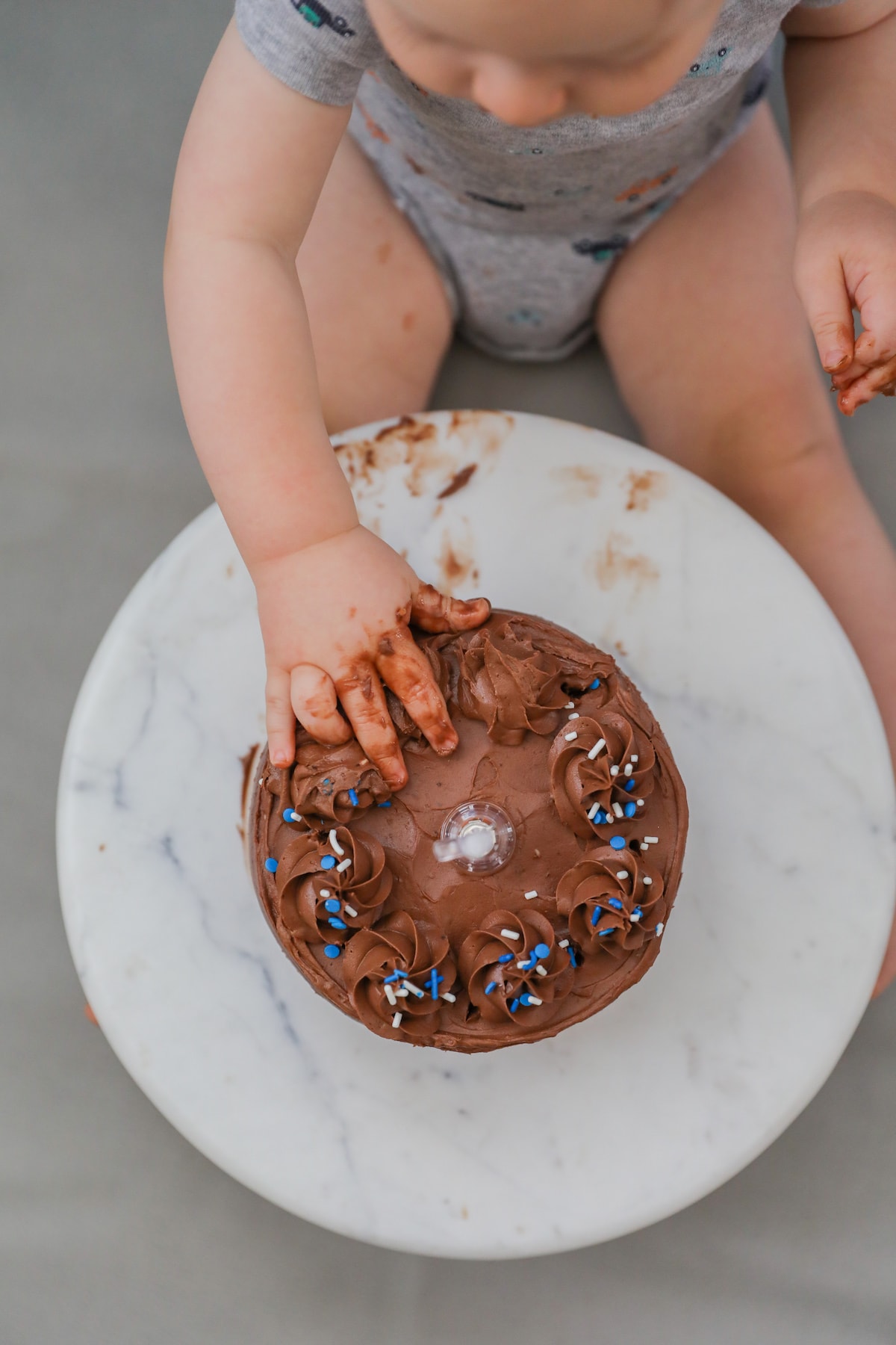 baby hand in chocolate cake