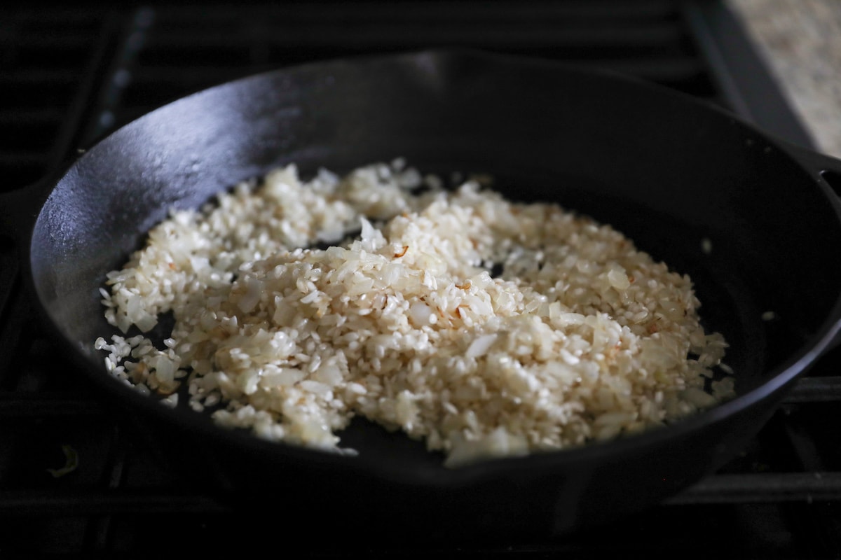onions, rice and butter in pan