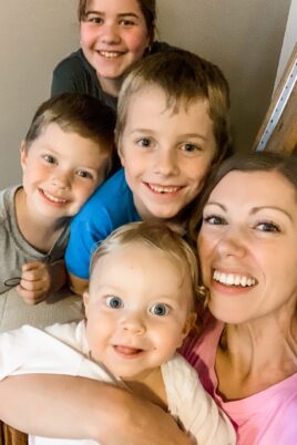 mom smiling with four kids