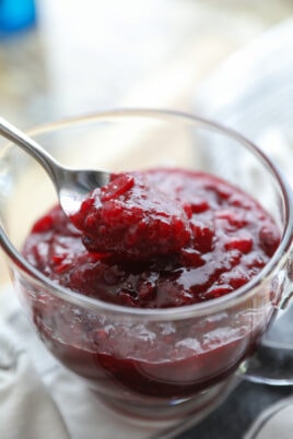 spooning cranberry sauce