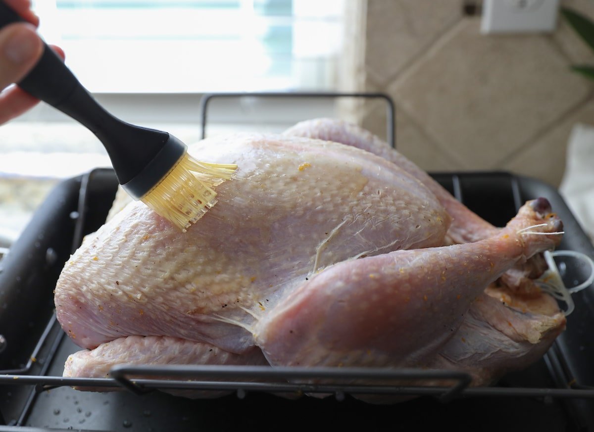 brushing turkey with melted butter