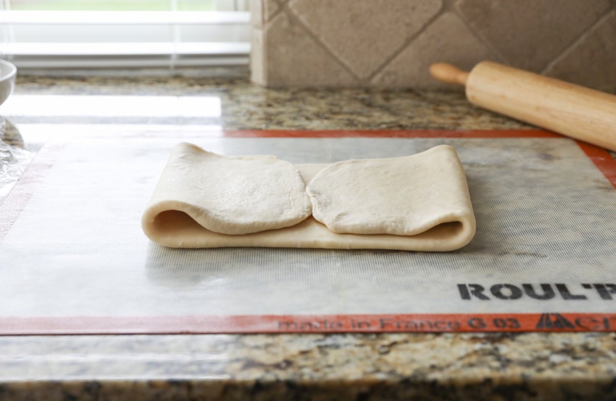 folding croissant dough to create layers