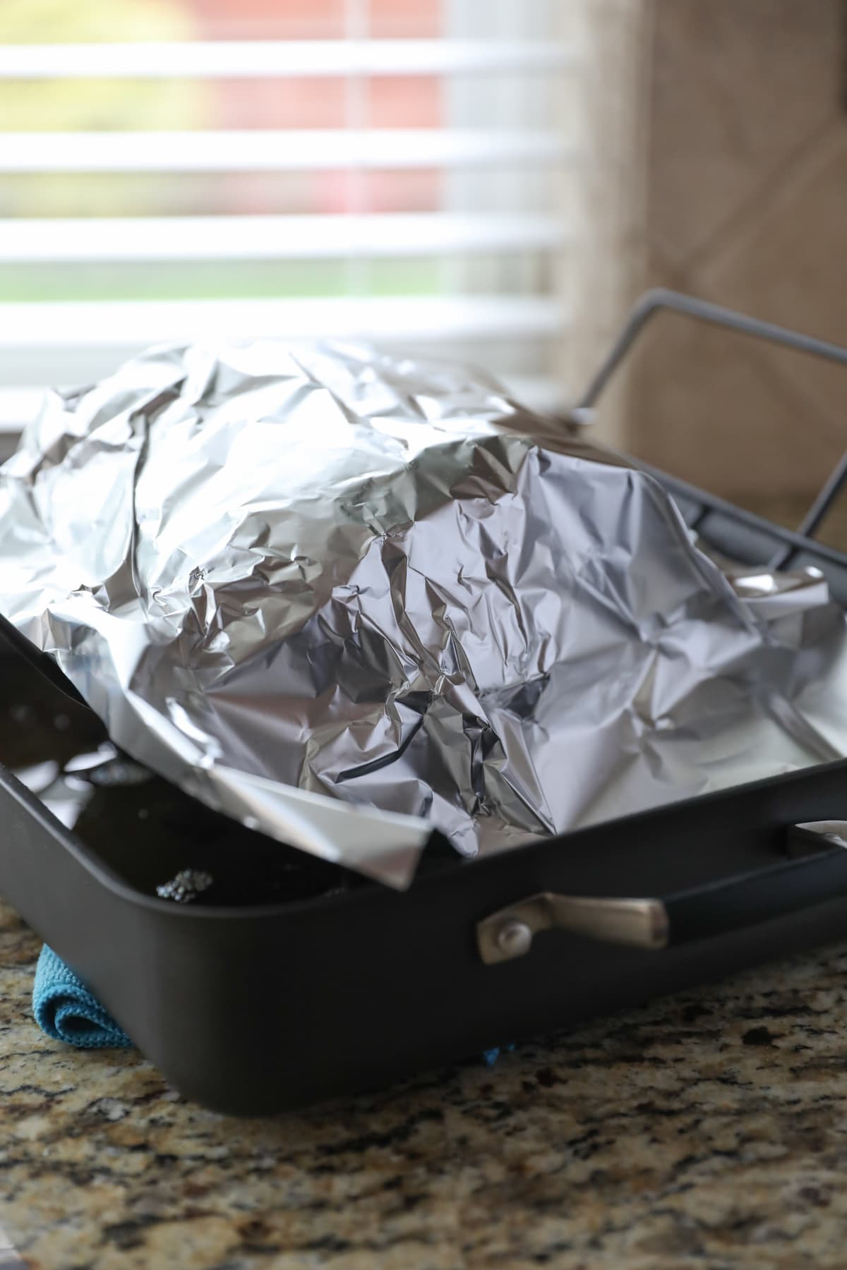 roasted prime rib covered in foil resting