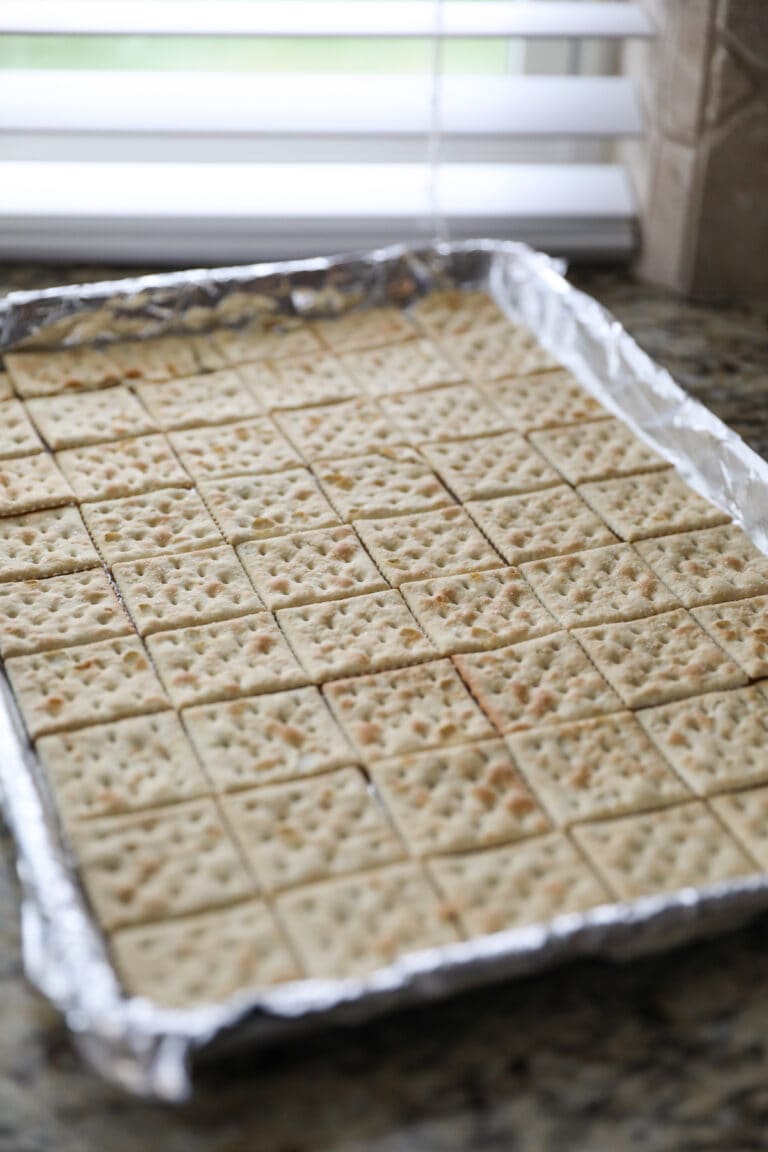 crackers lined on baking sheet