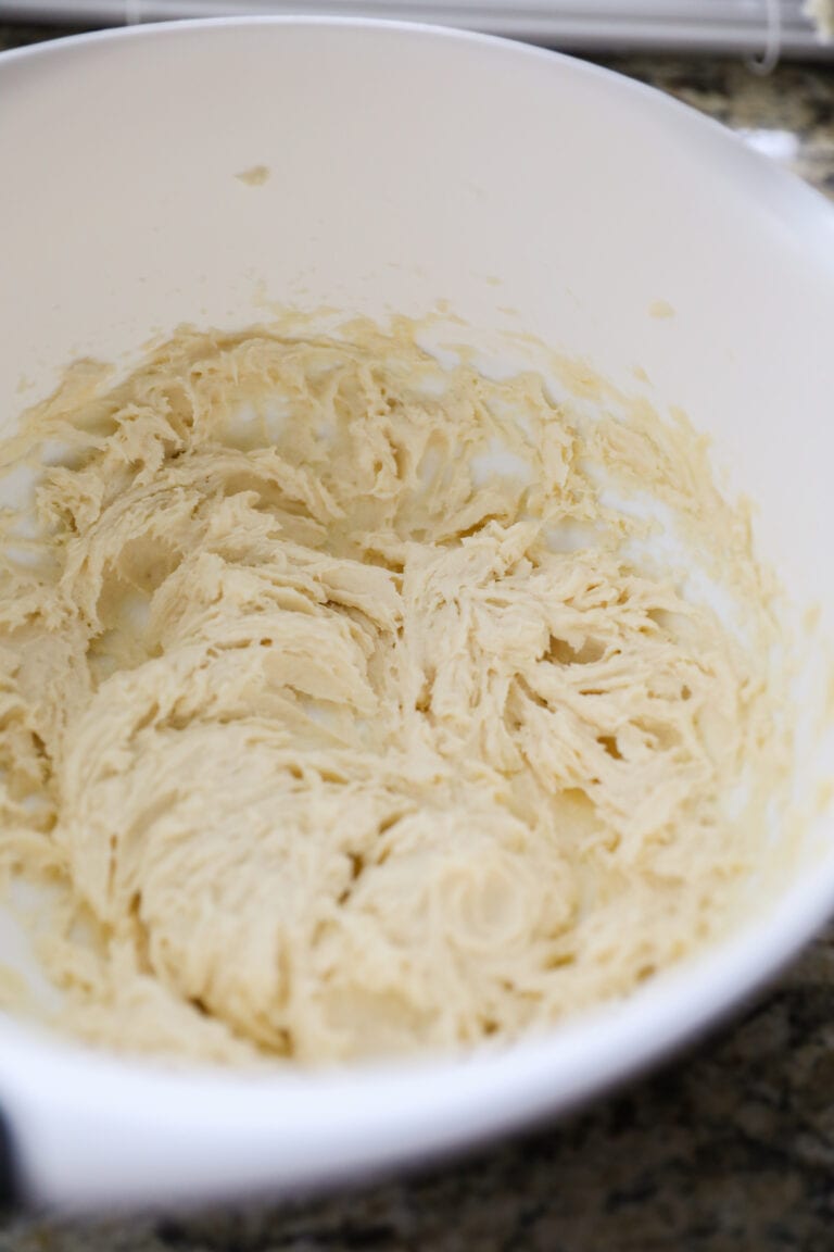 creamed butter, sugar, eggs, vanilla in white bowl