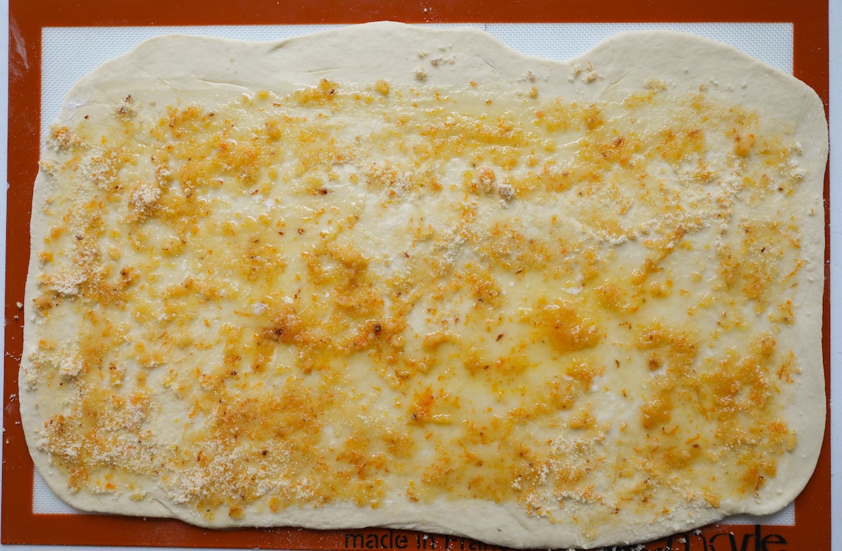 butter, orange zest and sugar on rolled out dough