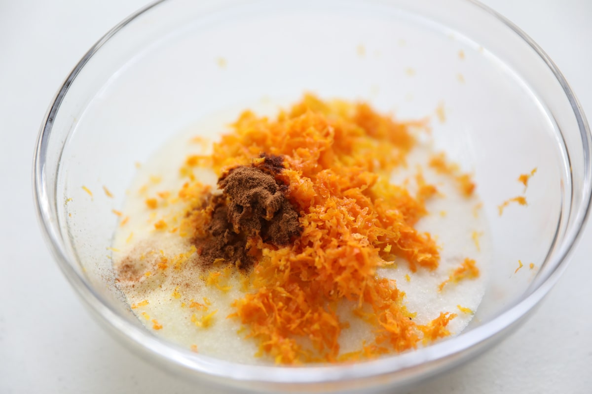 orange zest, cinnamon and sugar in glass bowl