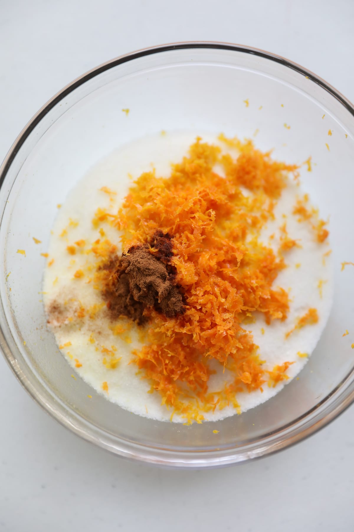orange zest, cinnamon and sugar in glass bowl