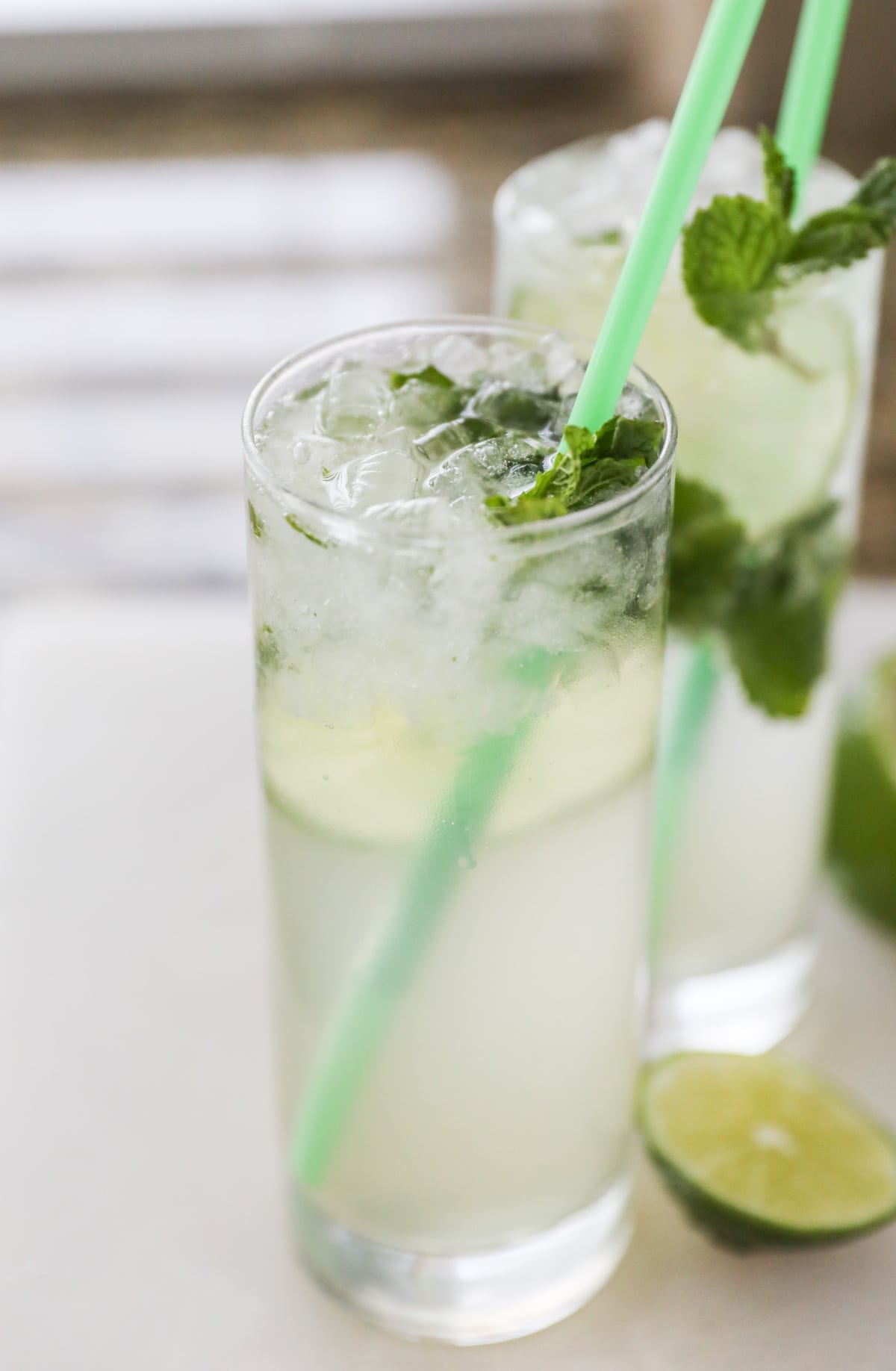 two mojito mocktails on white cutting board