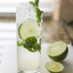 two mojito mocktails on white cutting board